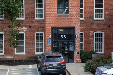 Building entrance with number 33 signage at Star Mill Lofts Apartments, Middleboro, MA 02370
