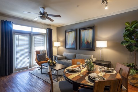 A dining room with a table set for a meal.