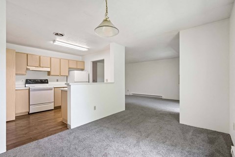 A kitchen with a white refrigerator and wooden cabinets.