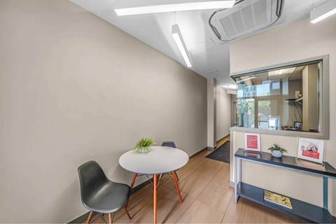 A room with a white table and a black chair.