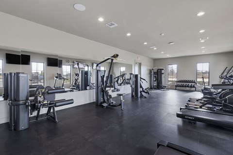 A spacious gym with various exercise equipment.