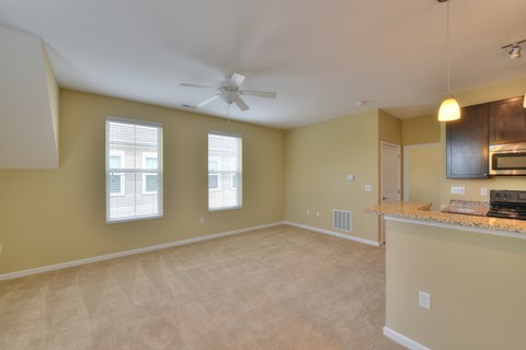 A spacious room with a ceiling fan and a window.