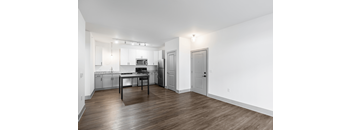 A kitchen with a table and chairs in the middle of the room.