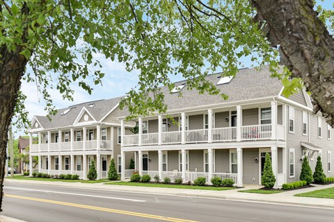 A large, two-story building with a balcony on the second floor.