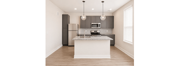 A kitchen with a white island and dark brown cabinets.