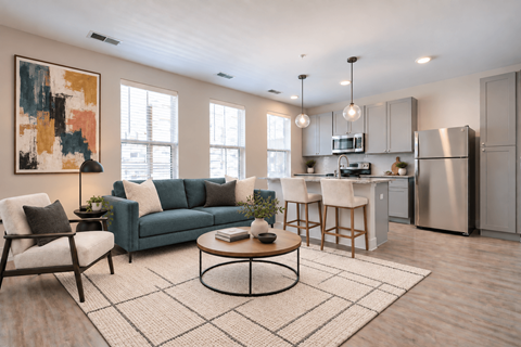 A modern kitchen and living room with a large abstract painting on the wall.