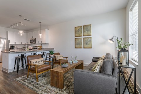 A living room with a grey couch and a wooden coffee table.