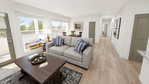 A modern living room with a grey sofa and a wooden coffee table.