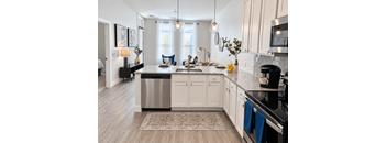 A kitchen with a large island and stainless steel appliances.
