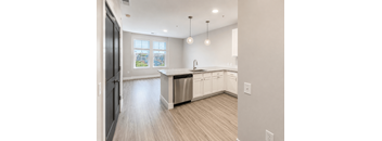 A kitchen with a large island and stainless steel appliances.