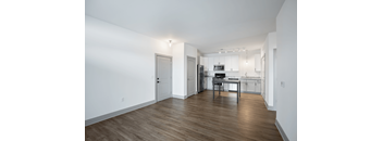 A kitchen with a table and chairs in the middle of the room.