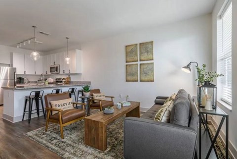 A living room with a grey couch and a wooden coffee table.