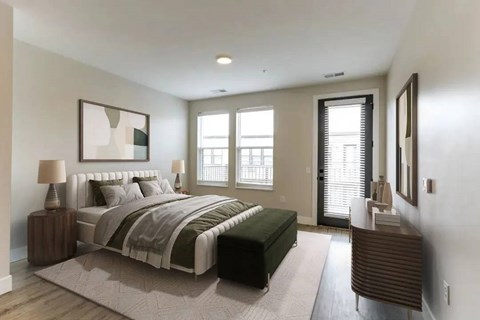 A bedroom with a large bed and a window with blinds.