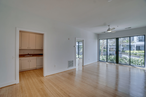 A room with wooden floors and a ceiling fan.