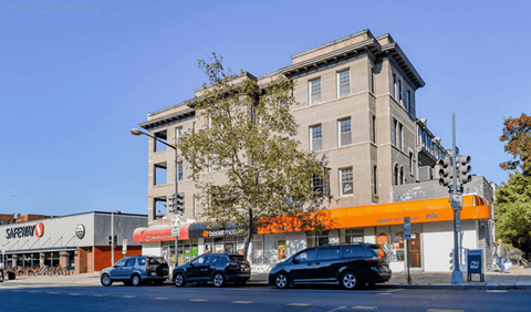 A Safeway store is located on the corner of a street.
