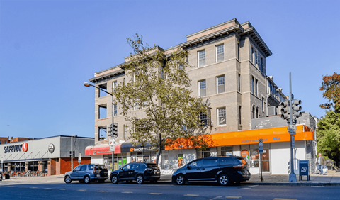 A Safeway store is located in front of a large building.