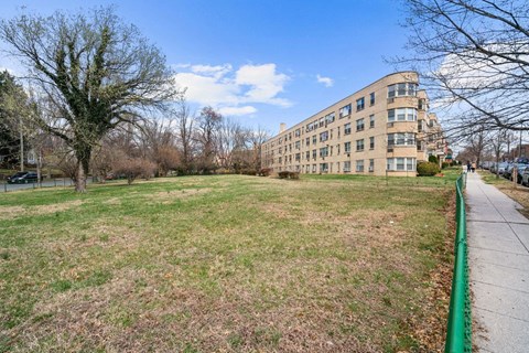 A grassy field with a building in the background.