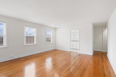 A room with wooden floors and white walls.