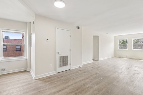 A spacious room with a door and a window.