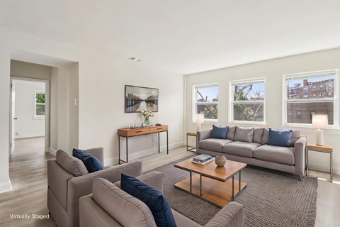 A living room with a grey couch and a coffee table.