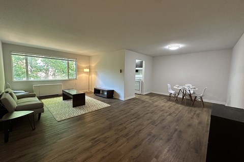 A living room with a couch, chair, and table.