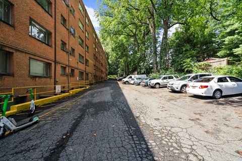 A parking lot with cars and a building in the background.