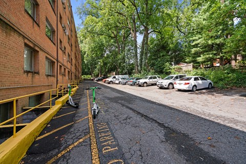 A parking lot with a yellow line and a sign that says "PARKING".