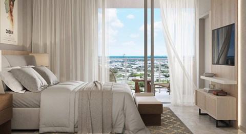 A bedroom with a large bed and a view of the city.
