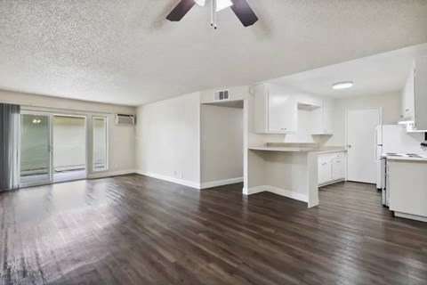 A room with wooden floors and white walls.