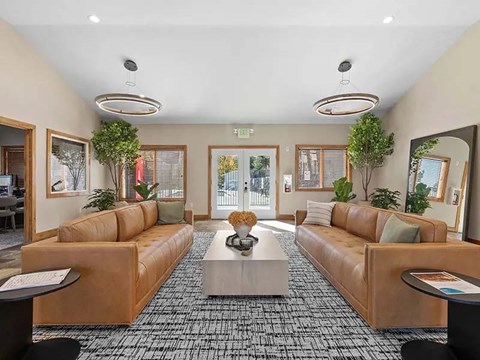 A spacious waiting area with tan couches and a coffee table.