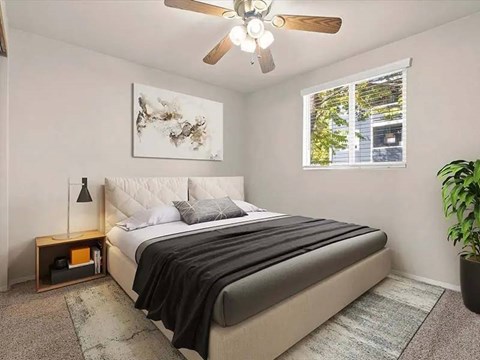 A bedroom with a large bed and a ceiling fan.
