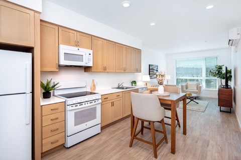 A kitchen with wooden cabinets and a white fridge.