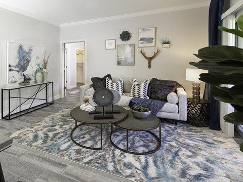 A living room with a white couch and a coffee table.