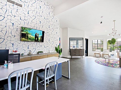 A modern dining room with a white table and chairs.