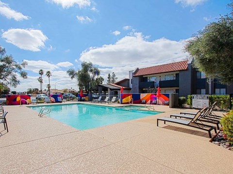 A swimming pool with a building in the background.