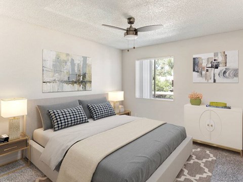 A bedroom with a large bed and a ceiling fan.