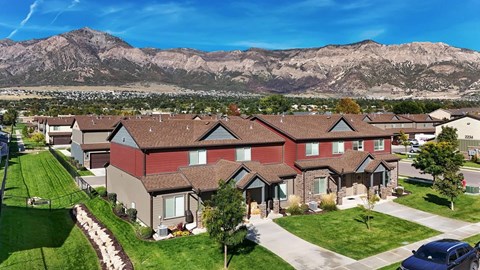 A row of houses with a mountain in the background.