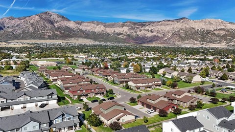 A suburban neighborhood with houses and a mountain range in the background.