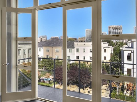 A view from inside a building looking out through a window at a cityscape.