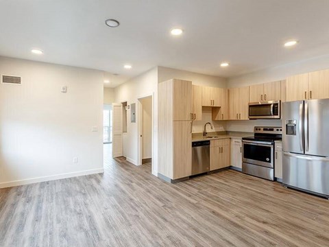 A kitchen with wooden cabinets and stainless steel appliances.