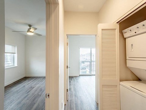 A room with a ceiling fan and a window.