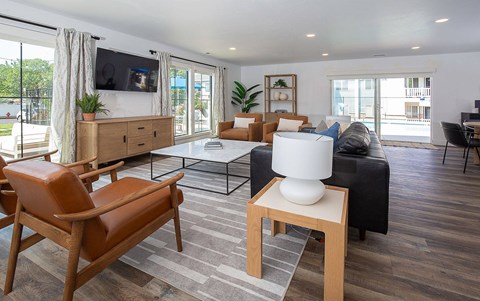 A living room with a brown leather chair and a white table.