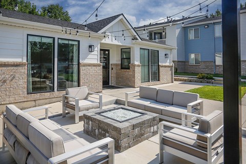A patio with a table and chairs and a hot tub.
