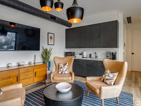 A modern living room with a large flat screen TV mounted on the wall.