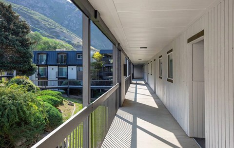 A long balcony with a view of a mountain.