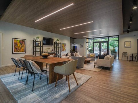 A modern dining room with a wooden table and chairs.