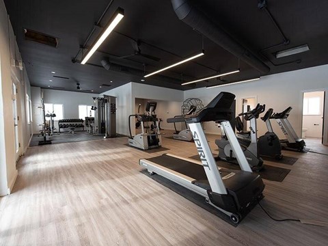 A gym with treadmills and other exercise equipment.