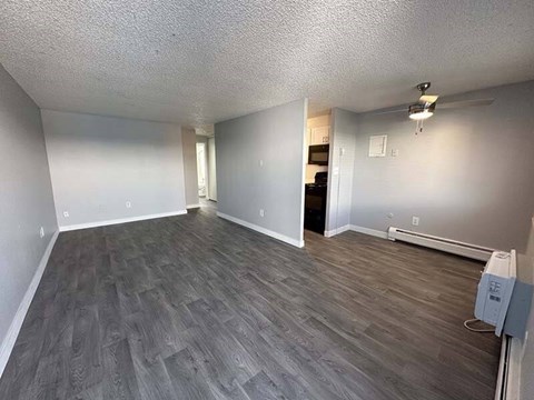 A room with grey flooring and white walls.