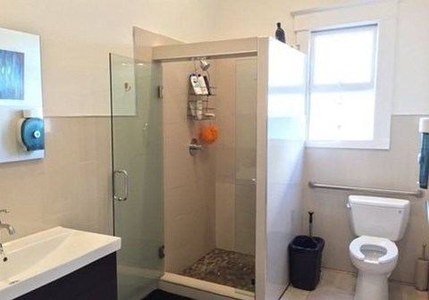 A bathroom with a toilet, sink, and shower.