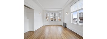 A room with wooden floors and white walls.